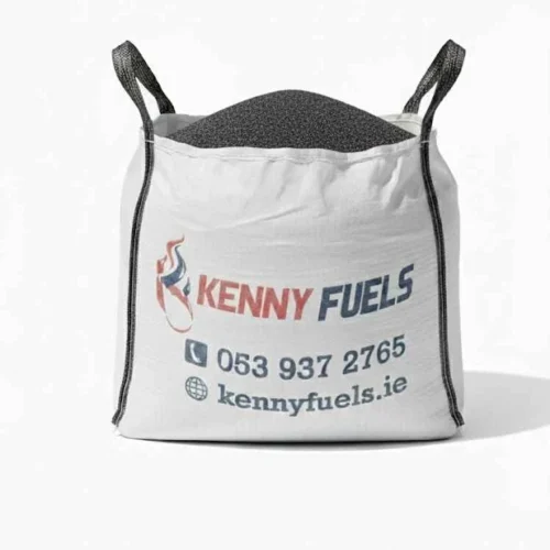 Large white bulk bag filled with black fuel pieces, branded “KENNY FUELS” with a flame logo and contact details. The bag has black lifting straps and sits outdoors, designed for handling and distribution.
