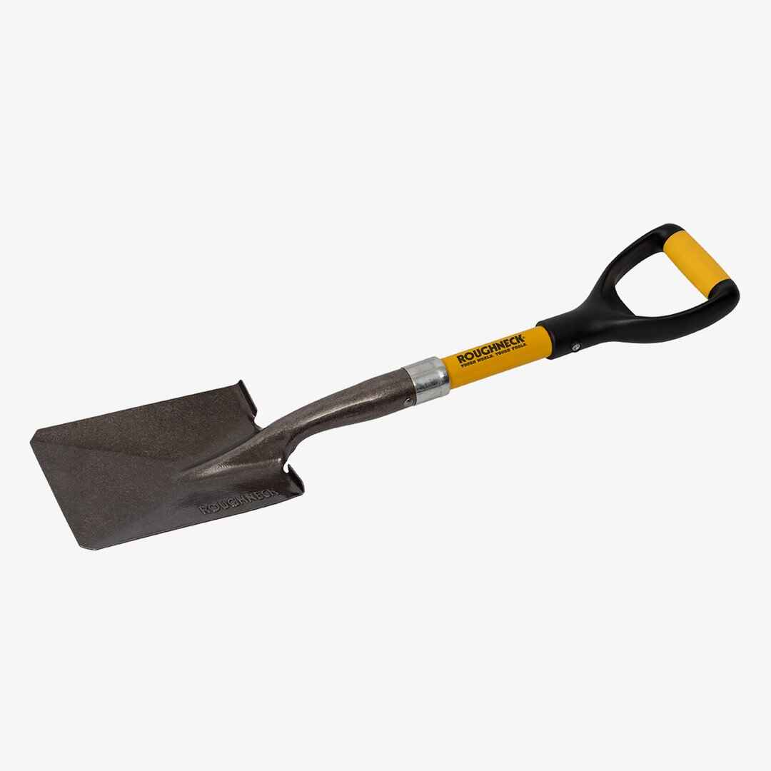 A sturdy spade-style shovel features a rectangular silver blade embossed with the brand “ROUGHNECK,” paired with a black shaft and a yellow D-grip handle bearing the same branding. The durable design and contrasting colors emphasize its use for heavy-duty digging or construction tasks.